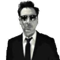 a man wearing sunglasses and a suit and tie