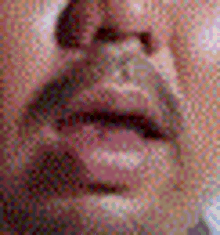 a close up of a man 's face with a blurred background .