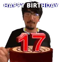 a man blowing out a candle on a cake that says happy birthday