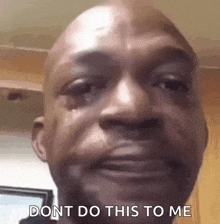 a close up of a man 's face with a tear coming out of his eye and the words `` dont do this to me ''