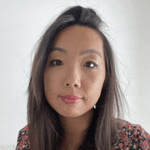 a close up of a woman 's face with long dark hair