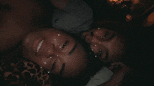 a man and a woman laying next to each other with sparkly eyes