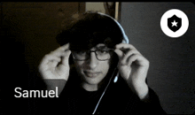 a person wearing glasses and a hoodie with the name samuel on the bottom