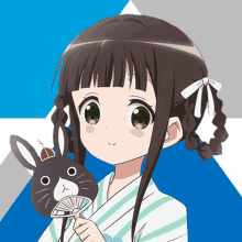 a girl holding a fan and a stuffed rabbit with a crown on it