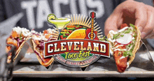 a cleveland taco fest logo with a guitar and margarita on it