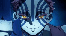 a close up of a person 's face with a blue and white striped face and yellow eyes .