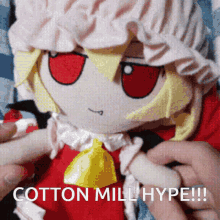 a person is holding a stuffed doll that says cotton mill hype on it