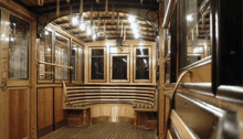 the inside of a wooden train car with a bench