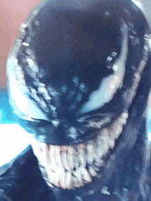 a close up of venom 's face with a very sharp teeth