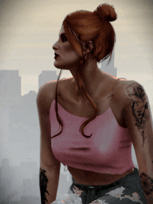 a woman in a pink tank top has a tattoo on her arm