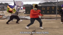 a group of people are dancing in front of a fence with the words awaken my masters written on it