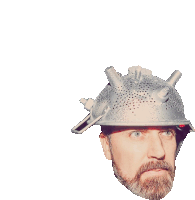 a man with a beard is wearing a helmet made of a strainer