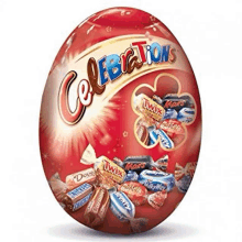 a red easter egg filled with candy including snickers , twix , and mars .