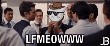 a group of men are standing around a cat wearing sunglasses and a hat with the words lfmeowww written on it