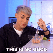 a man is holding a fork over a bowl of food with the words " this is so good " above him