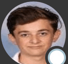 a close up of a young boy 's face with a circle around it