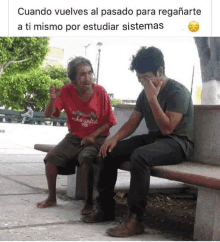 a man in a red shirt sits next to another man on a bench