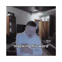 a man is mocking his word while standing in a room
