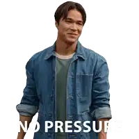a man in a denim jacket is standing in front of a white background that says no pressure