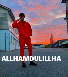 a man in a red outfit is standing in front of a building with the words allhamdulillha on it