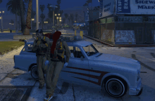 two people standing next to a car in front of vespucci