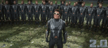 a man in a futuristic suit stands in front of a large group of soldiers with the number 2.0 on the bottom right