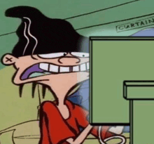 a cartoon character is sitting in front of a computer monitor .