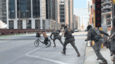 a man on a bike is being chased by police officers