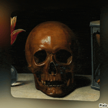 a skull sits on a table next to a hourglass