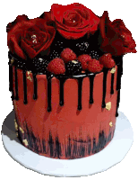 a red cake with raspberries and blackberries on top