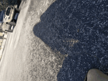 a jeep is parked on the side of the road with a shadow on the ground