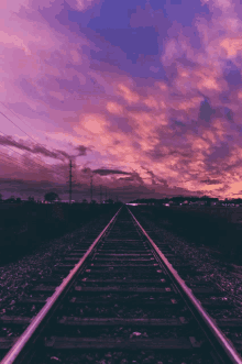 train tracks with a sunset in the background