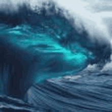 a large wave in the ocean is breaking on the shore