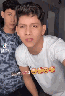 two young men are posing for a picture and one of them has a tiktok account
