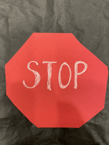 the word stop is written in white on a red sign