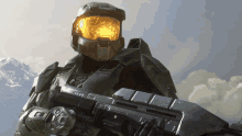 a man in a halo helmet holding a gun with a green light