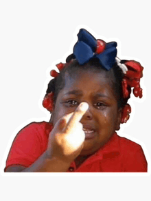 a little girl is crying and making a middle finger gesture .