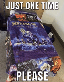 a bed with a blanket that says megadeth rest in peace on it