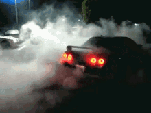 a car is driving through a cloud of smoke