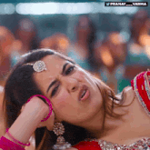 a woman in a red top is making a funny face with the hashtag pranay_varma below her