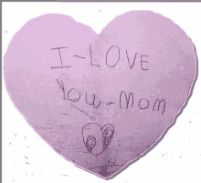 a heart shaped piece of paper with the words i love you mom written on it