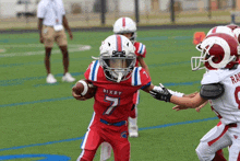 a young football player wearing a red jersey with the number 7 on it