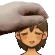 a person is petting a cartoon character 's head with a towel .