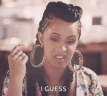 a woman wearing hoop earrings is making a funny face and saying `` i guess '' .