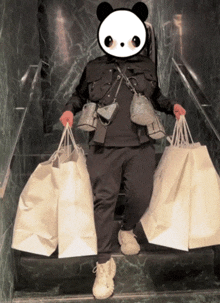 a panda bear is standing on a set of stairs holding lots of shopping bags