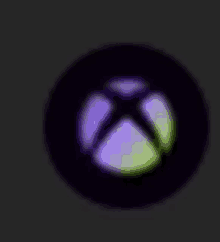 the xbox logo is glowing in the dark and has a purple and green gradient