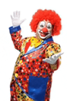 a clown with a red wig and a blue tie is waving .