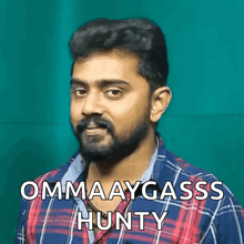 a man with a beard is wearing a plaid shirt and says ommaaygass hunty