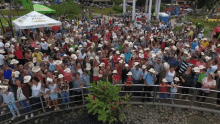 a large group of people wearing cowboy hats are standing in front of a canopy that says " pueblo "