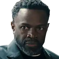 a man with a beard looks at the camera with a serious look on his face